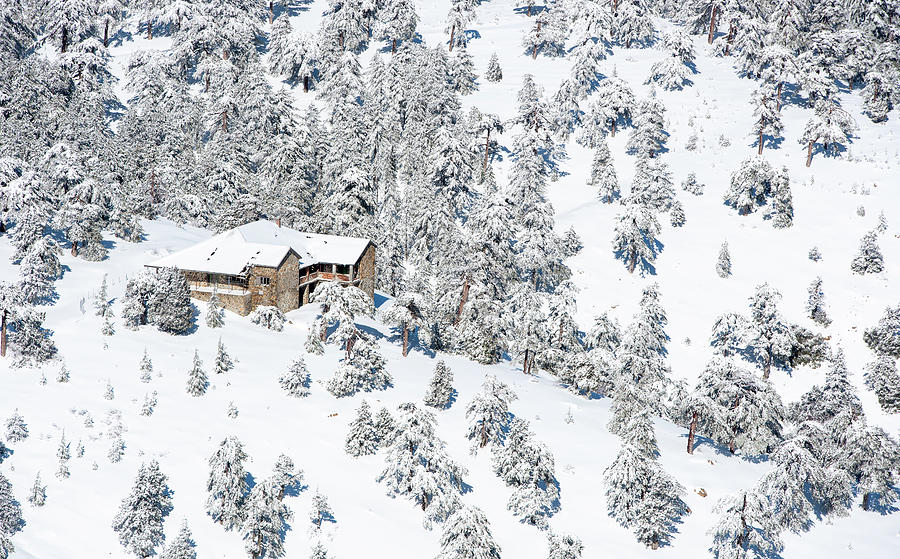 Lonely chalet house at the slope of a snowy mountain in winter. Photograph by Michalakis Ppalis