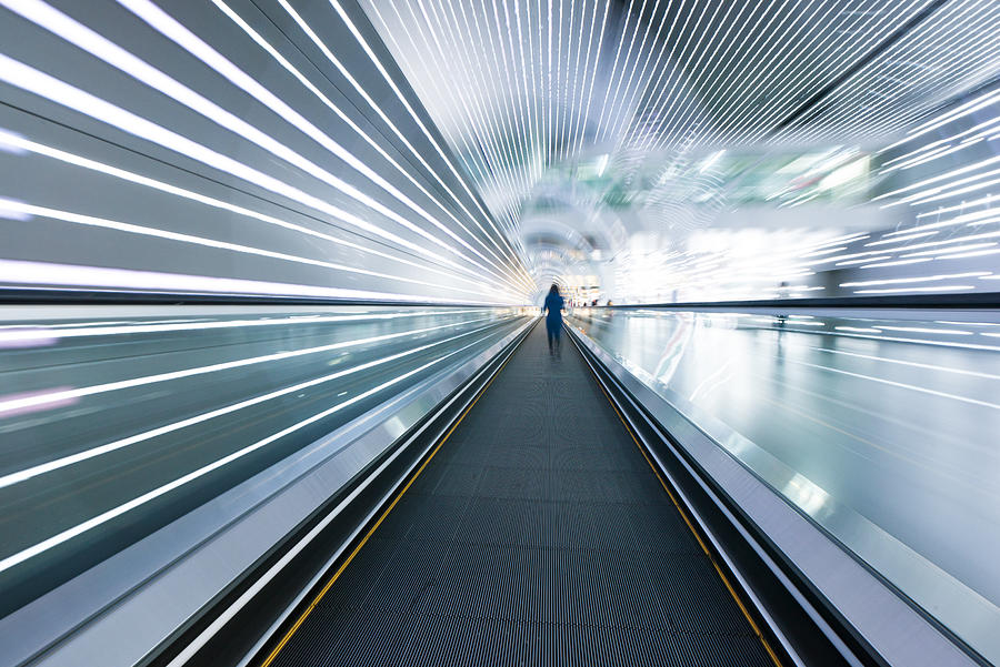 Long horizontal escalator at international airport terminal Photograph by Yangyang