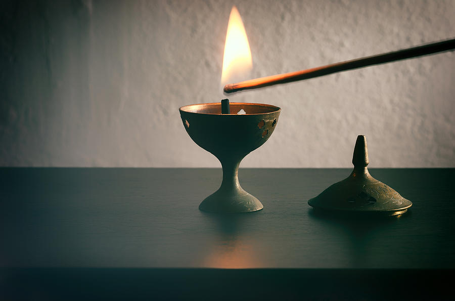 Long match lighting an incense cone. Photograph by Harpazo_hope