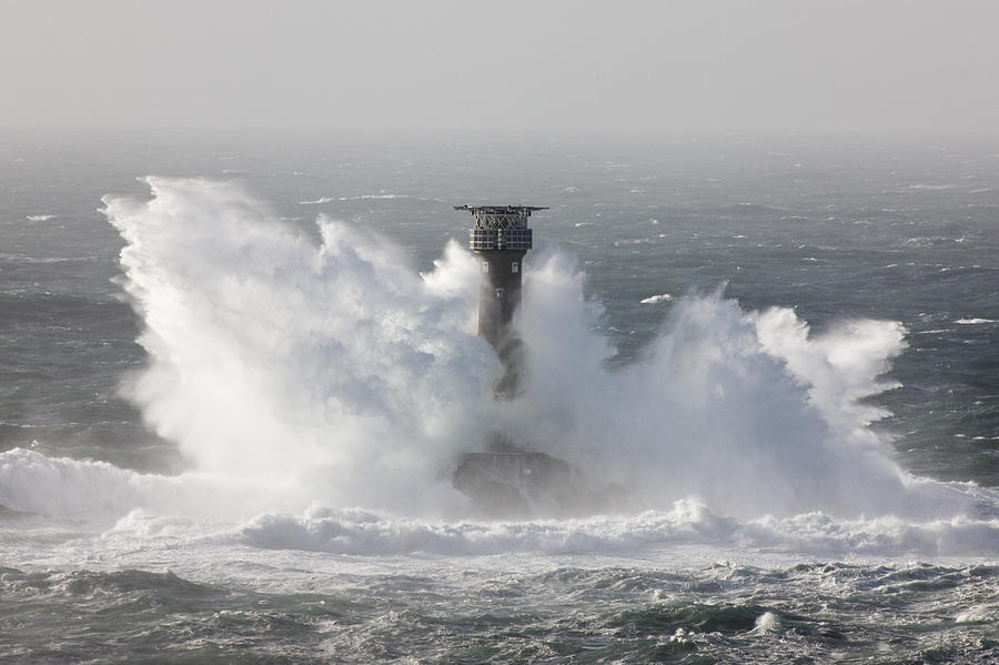 Longships Lighthouse being pounded by waves during an Atlantic storm. Lands End, Cornwall, England, UK Photograph by David Clapp