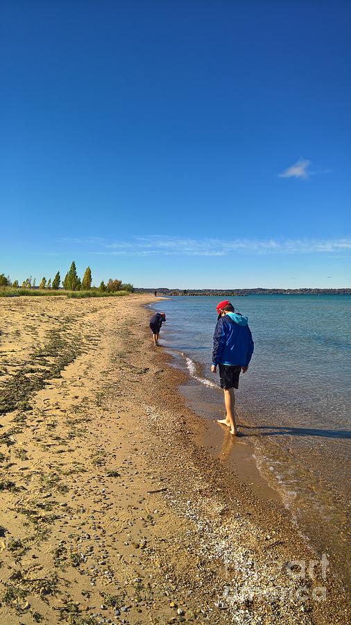 Looking for Petoskey Stones  Photograph by Lisa Dionne