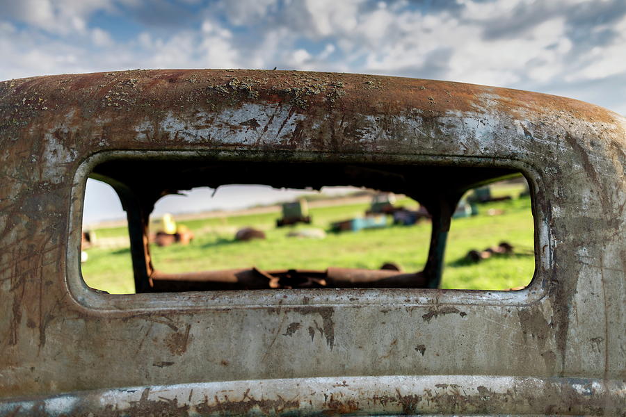 Looking through an Old Truck Window to a truck graveyard Photograph by Art Whitton