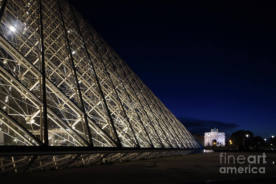 Louvre entrance pyramid and the Arc de Triomphe du Carrousel Photograph by Rudi Prott
