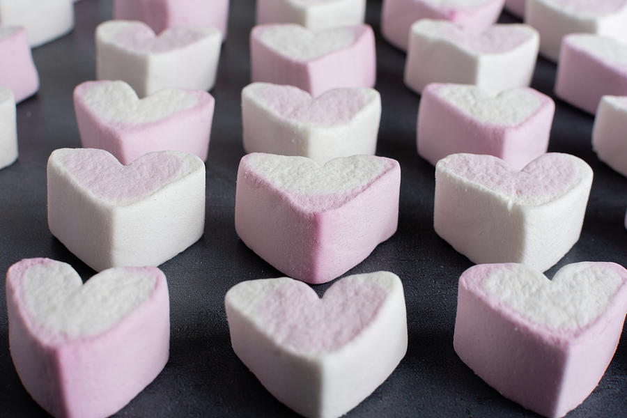 Love heart marshmallows lined up Photograph by Scott Lyons