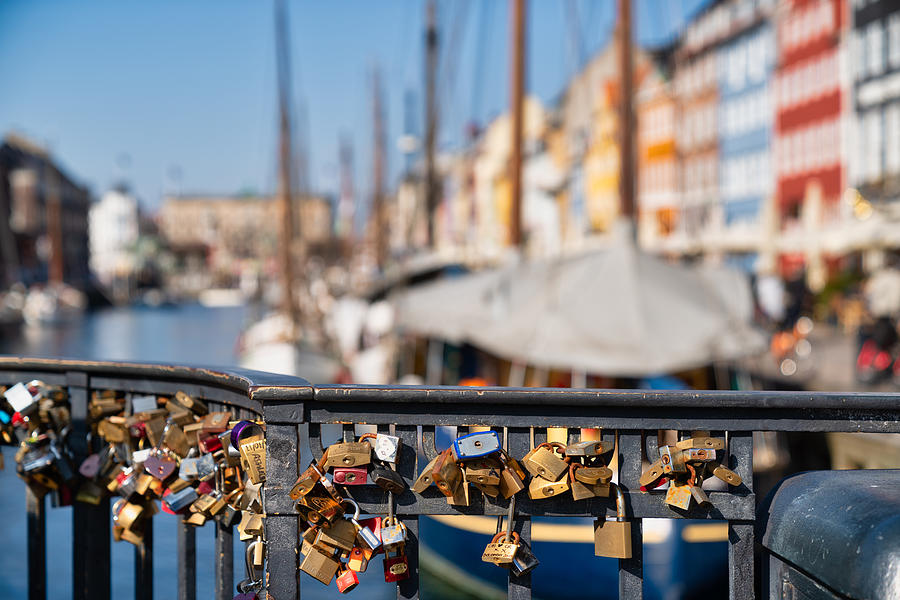 Love locks hanging on the bridge in the foreground, Nyhavn, Copenhagen Photograph by Mauro Tandoi