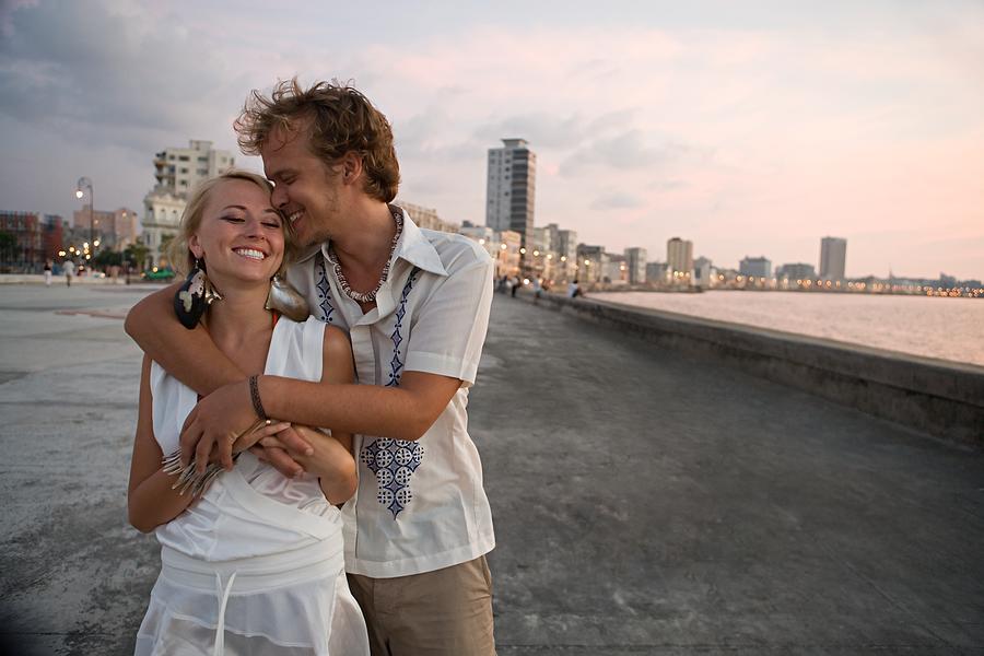 Loving couple on coastal boulevard Photograph by Image Source