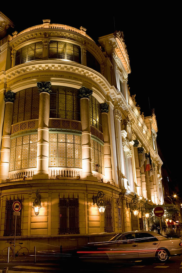 Low angle view of a building lit up at night, Nice, France Photograph by Glowimages