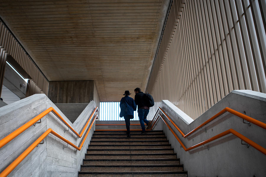 Low angle view of a woman and a man moving up the steps Photograph by Photographer, Basak Gurbuz Derman