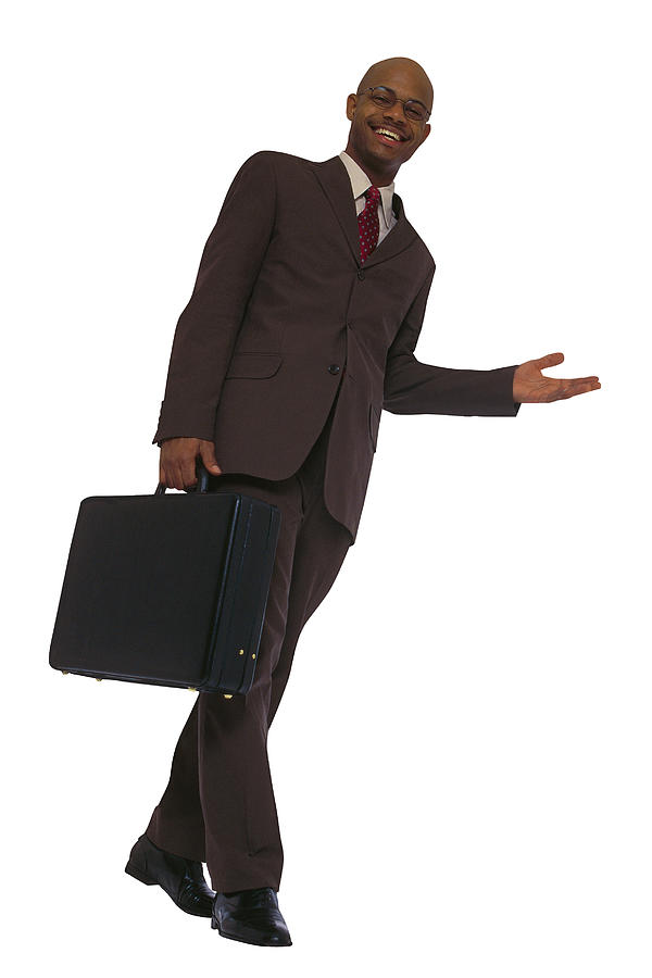 Low angle view of businessman with briefcase Photograph by Comstock