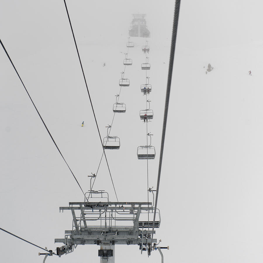 Low angle view of skiers on ski lifts Photograph by Fotosearch