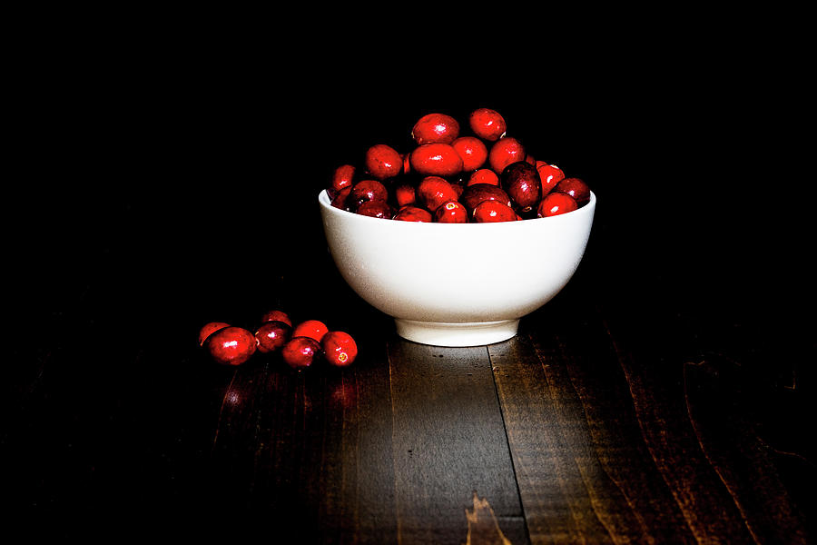 Low Key Cranberries in White Porcelain Bowl on Brown Wood Base Photograph by Charles Floyd