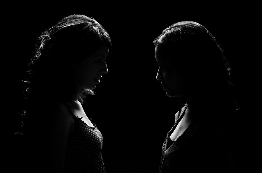 Low Key Lit Portrait of Two Woman Facing Each Other Photograph by Aldomurillo