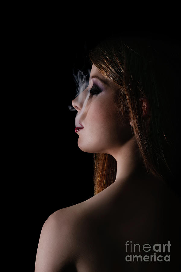 Low key portrait of a woman with smoke coming out of her mouth Photograph by Mendelex Photography