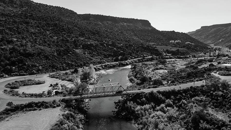 Low road to Taos New Mexico with bridge in black and white Photograph by Eldon McGraw