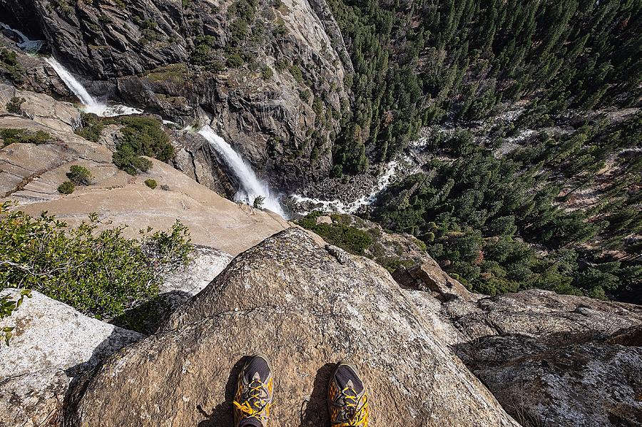 Low Section Of Man Standing On Rock At Cliff Over Waterfall Photograph by Patrick Walsh / EyeEm Low Section Of Man Standing On Rock At Cliff Over Waterfall Photograph by Patrick Walsh / EyeEm