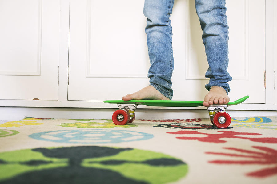 Low Section  Of Young Boy Skateboarding At Home Photograph by Carol Yepes