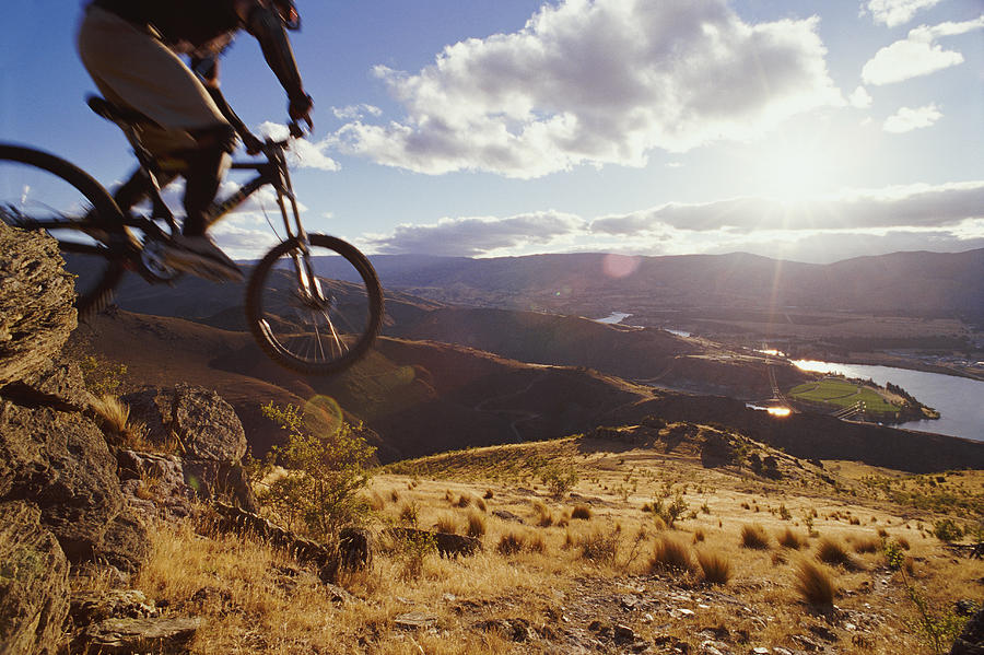 Low Section Shot of a Cyclist Riding a Mountain Bike Down a Hill, Otago, New Zealand Photograph by Darryl Leniuk