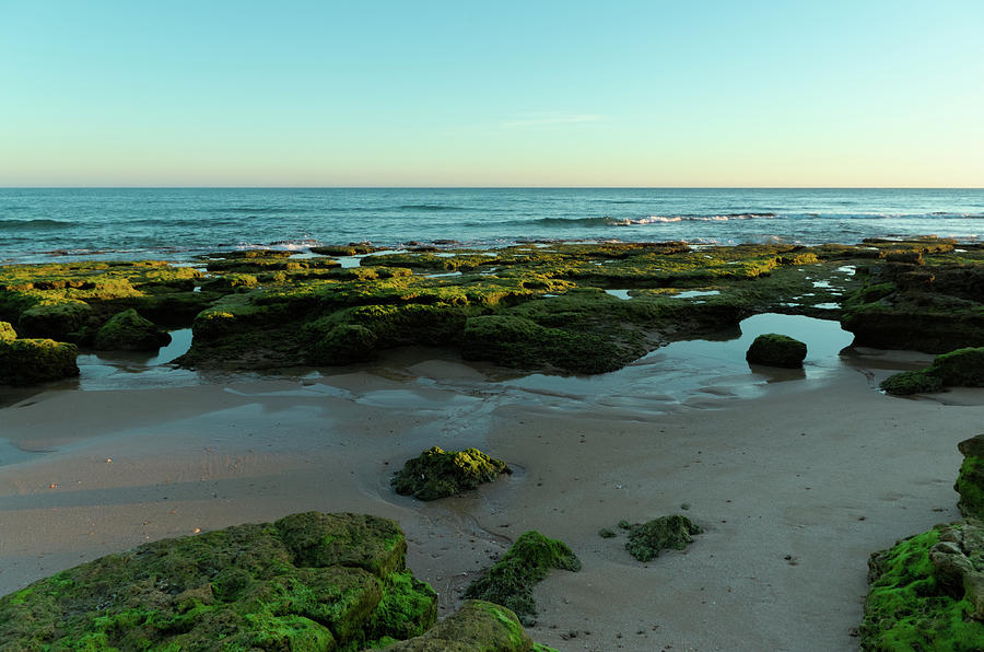 Low tide, sunset and rocks Photograph by Angelo DeVal
