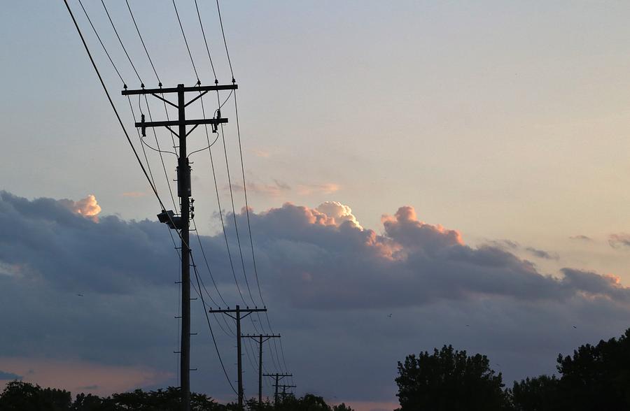 Low voltage power lines connecting residential neighborhoods to the power grid Photograph by Douglas Sacha