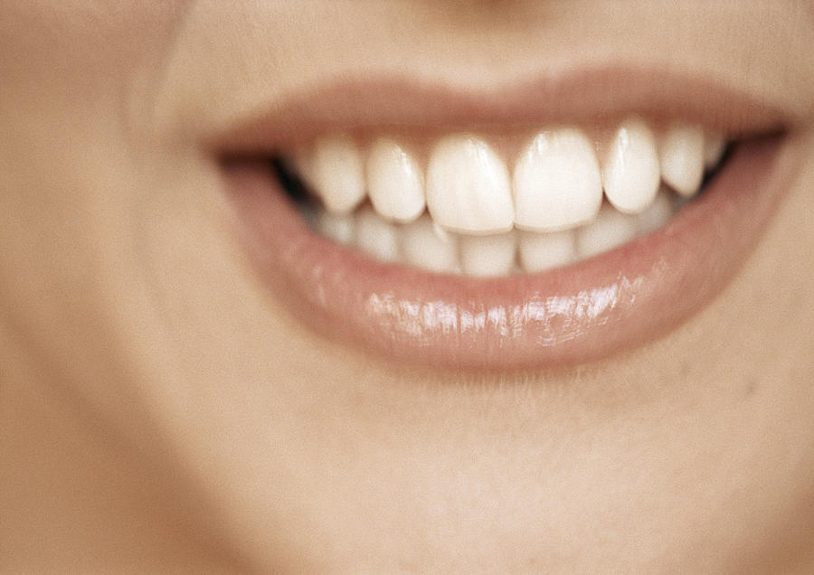 Lower section of womans face, toothy smile, extreme close-up Photograph by Isabelle Rozenbaum
