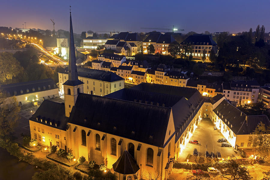 Luxembourg, Luxembourg City, Neumunster Abbey, Illuminated church and surrounding cityscape Photograph by Henryk Sadura