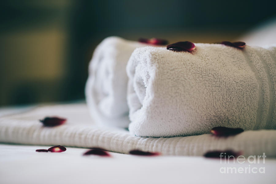 Luxury hotel room with white spa towels on bed sheet with rose p Photograph by Jelena Jovanovic