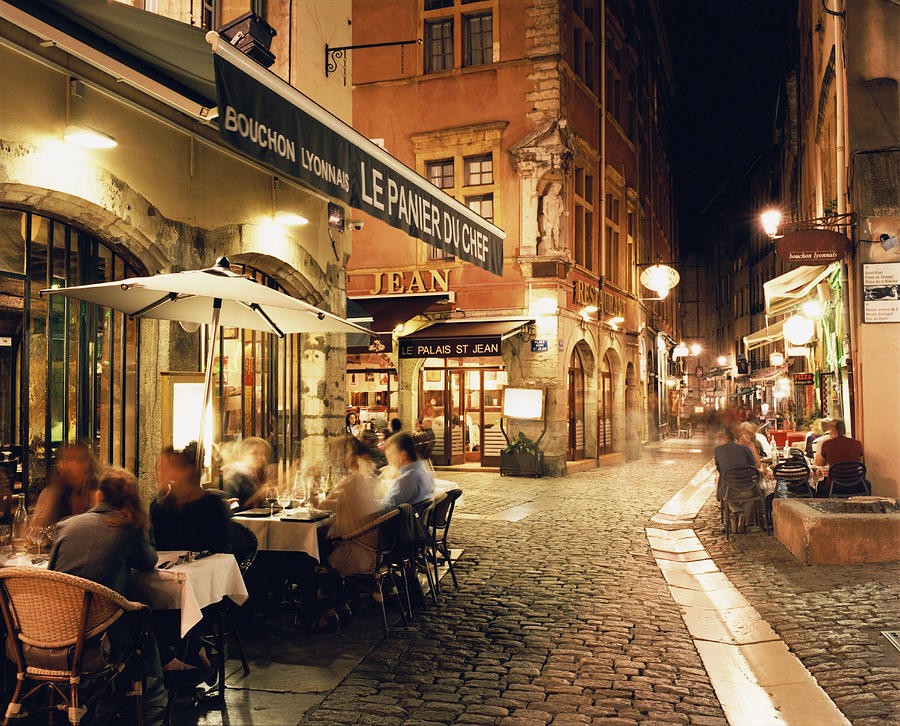 Lyon, People dining along cobbled street at night Photograph by Gary Yeowell