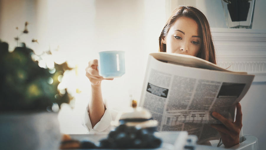 M orning routine with coffee and newspapers. Photograph by Gilaxia