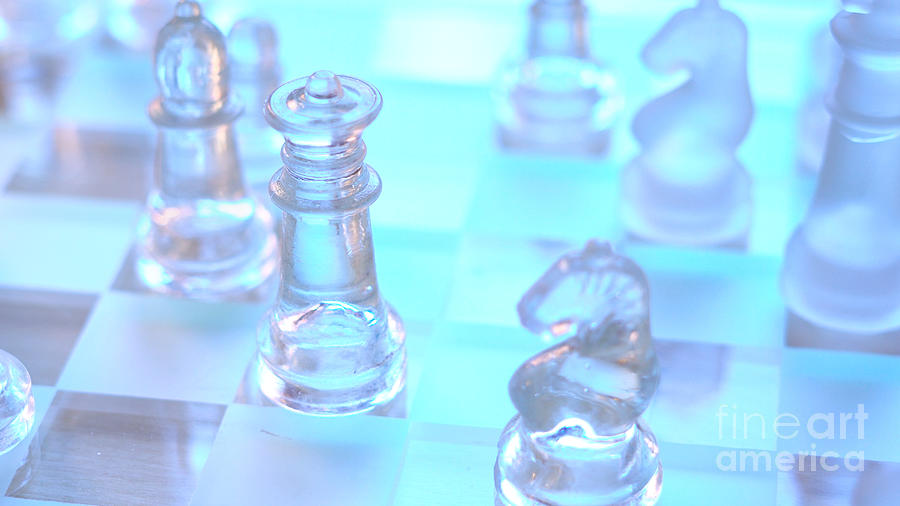 Macro closeup of glass chess pieces in natural light. Photograph by Milleflore Images