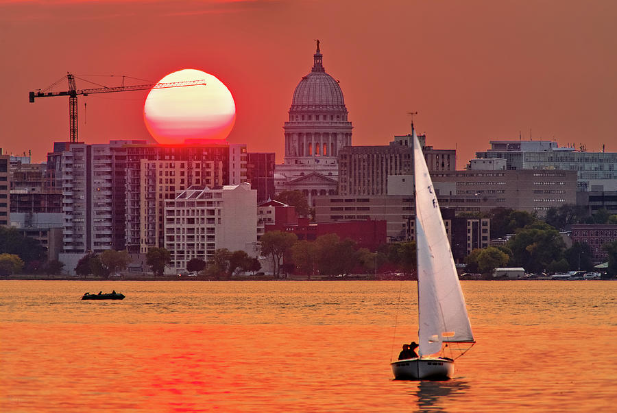 Madison Equinox - Sun setting near madison WI capitol dome with lake monona and sailboat Photograph by Peter Herman