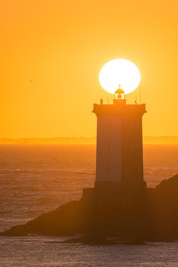 Magic sunset in Le Conquet behind the lighthouse Photograph by MathieuRivrin