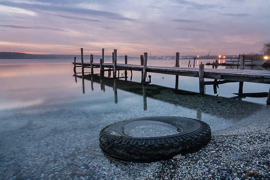Magnificent Sunset Abandoned Tire, Wooden Pier On The Lake. A Tranquil Sunset Over A Varna Lake. Photograph