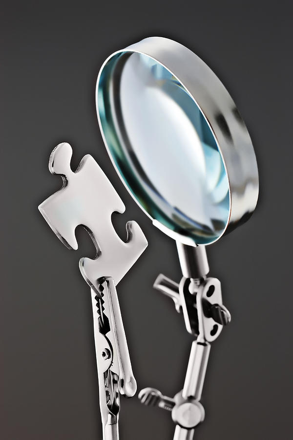 Magnifying Glass And Puzzle Piece Photograph by David Muir