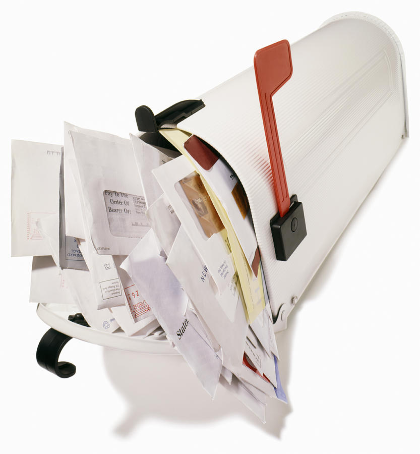 Mailbox stuffed overflowing with bills,  junk mail Photograph by Steve Wisbauer