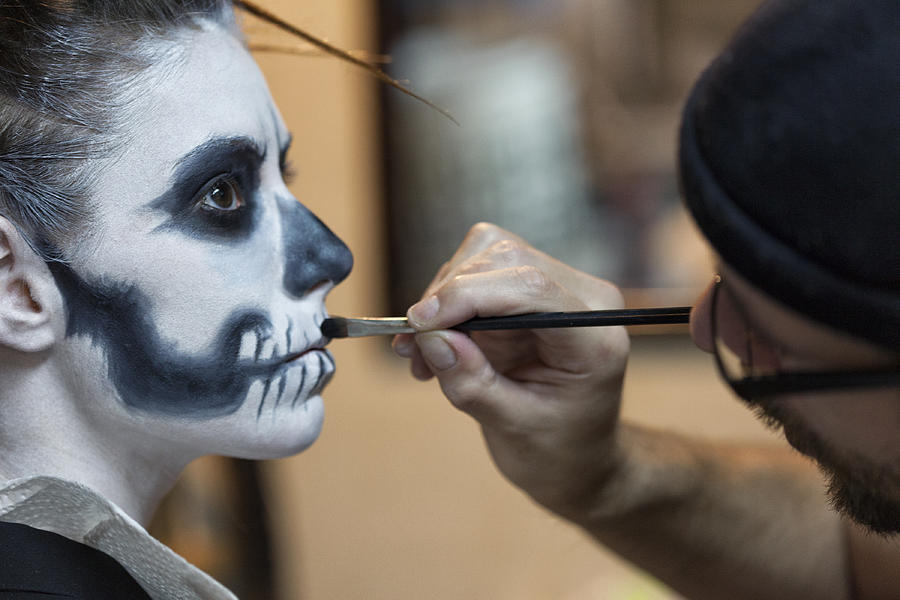Makeup Artist applying Skeleton Makeup on a Woman Photograph by Powerofforever