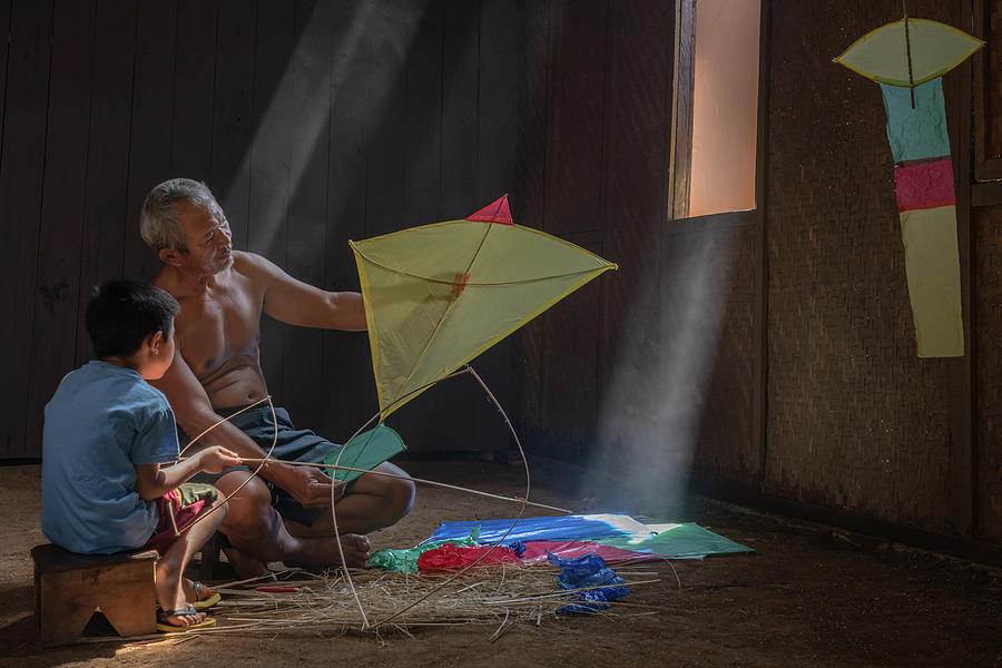 Making a kite together Photograph by Anges Van der Logt