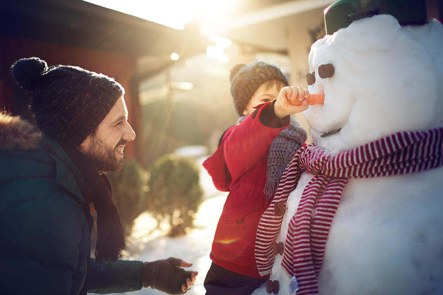 Making a snowman with my dad Photograph by AleksandarNakic