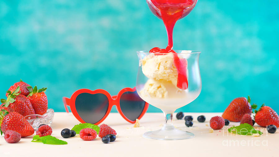 Making summertime gourmet berry and vanilla ice cream sundae. Photograph by Milleflore Images