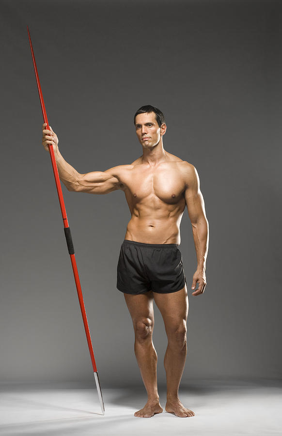 Male athlete holding javelin, studio shot Photograph by Siri Stafford