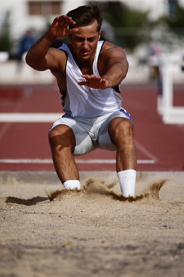 Male Athlete In Long Jump Competition Photograph by Terje Rakke