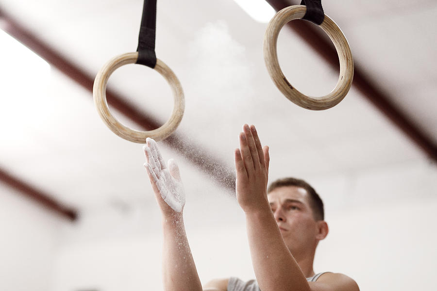 Male athlete preparing for training on gymnastic rings Photograph by Capuski