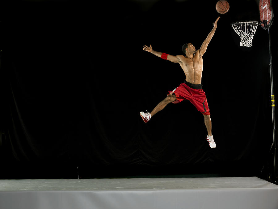 Male Basketball Player in Mid Air and Aiming for the Hoop, Studio Shot Photograph by 10000 Hours