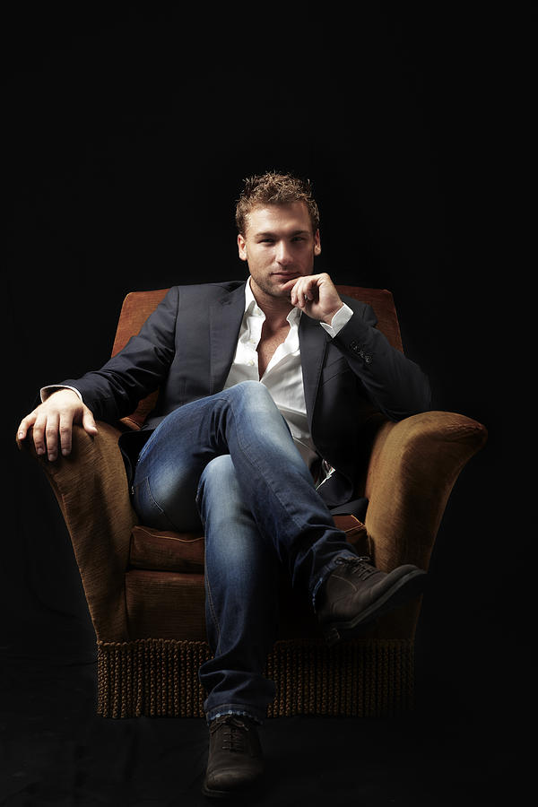 Male Beauty sitting on Armchair. Color Image Photograph by Claudio.arnese