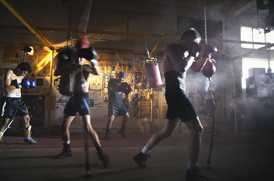 Male boxers working out in gym (blurred motion) Photograph by Yellow Dog Productions