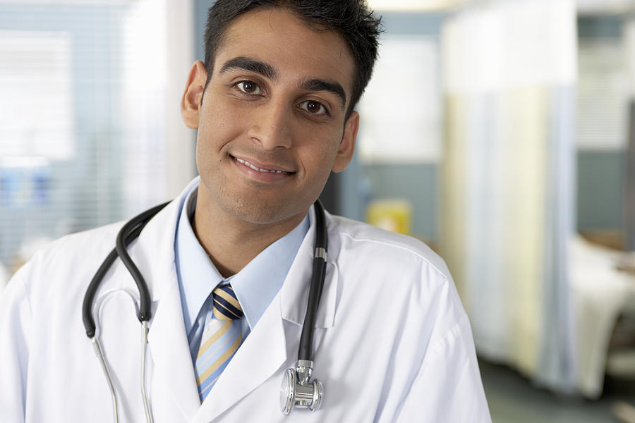 Male doctor smiling, portrait, close-up Photograph by Darrin Klimek