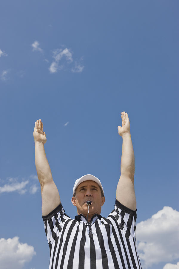 Male football referee making touchdown call Photograph by Tetra Images