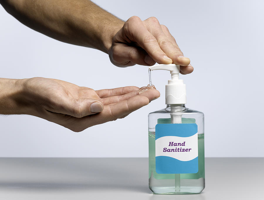 Male Hands Dispensing Hand Sanitizer Photograph by Jeffrey Coolidge