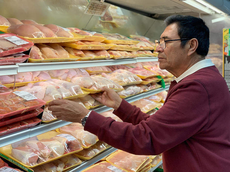 Male Hispanic Senior Citizen buying packaged chicken at the grocery store Photograph by Sonia Tapia Male Hispanic Senior Citizen buying packaged chicken at the grocery store Photograph by Sonia Tapia