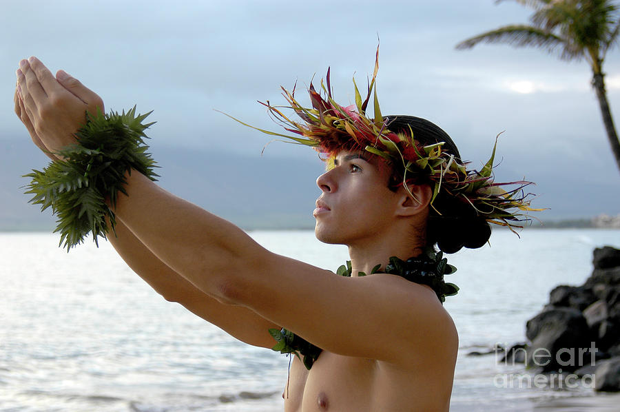 Male Hula Dance performs on the beach with expressive hand movements.	 Photograph by Gunther Allen