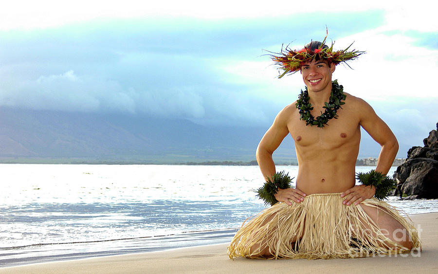 Male Hula Dancer smiles as he kneels on the beach in a hula dance pose. Photograph by Gunther Allen